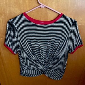 A black and white striped crop top with a knot in the middle of the shirt.